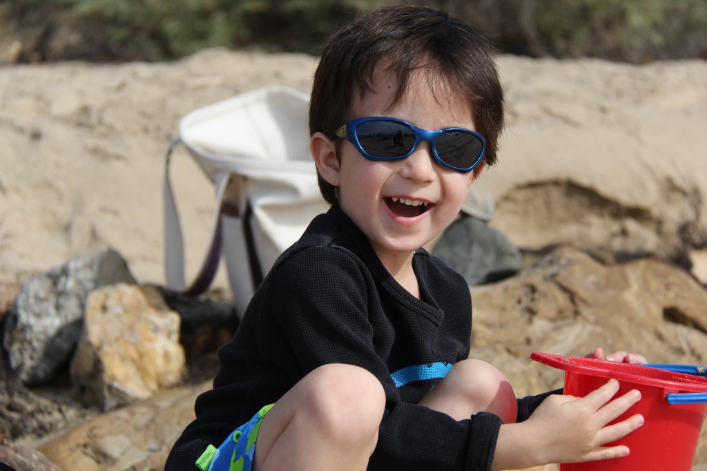 li'l G building what i think is a sand castle...but is probably a UFO or something